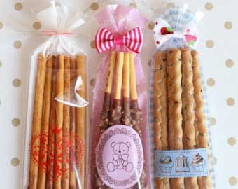 Wrap chocolate dipped bread sticks or candied bread sticks.